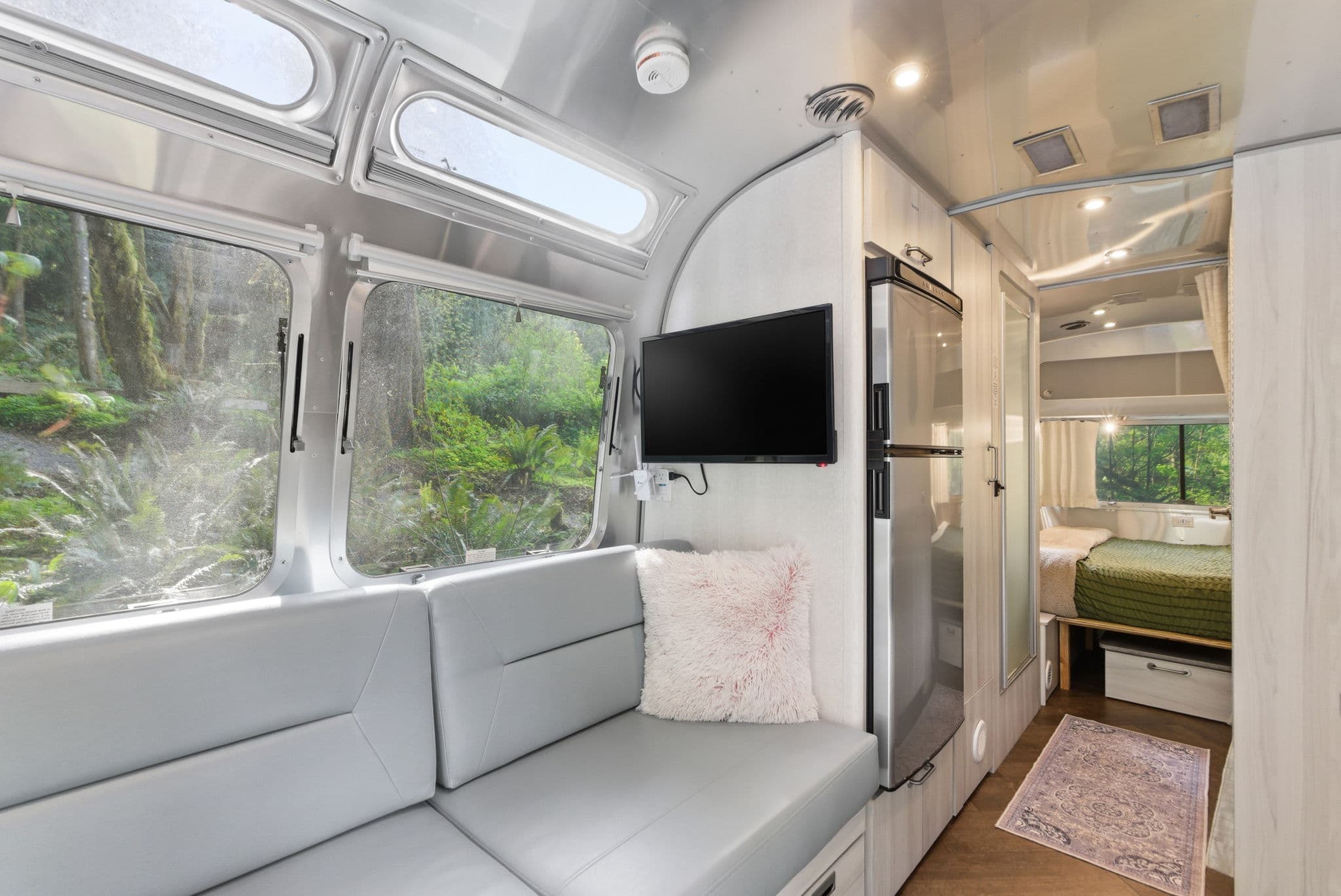 Airstream lounge with TV and view through to the bedroom