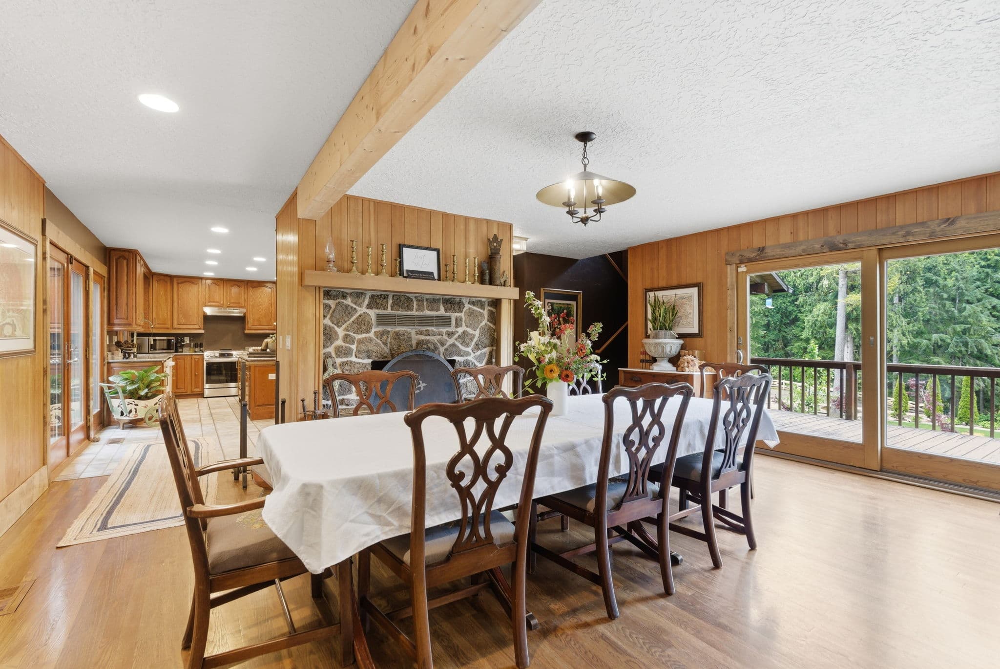 Formal dining room with a stone fireplace and seating for ten