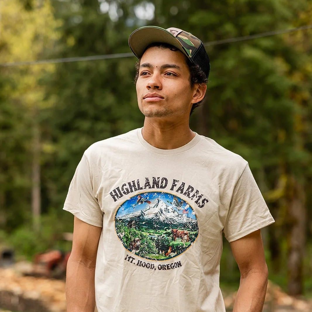 Wearing the Dream hoodie in cream, outdoors among trees