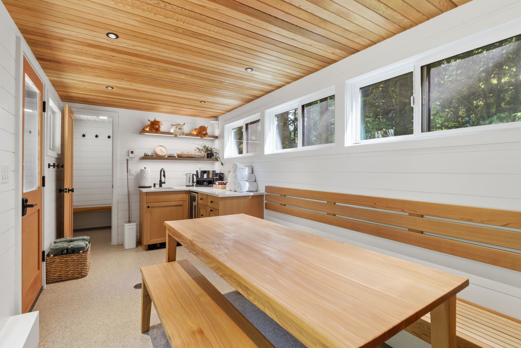 Cedar communal table and bench seating between sauna sessions