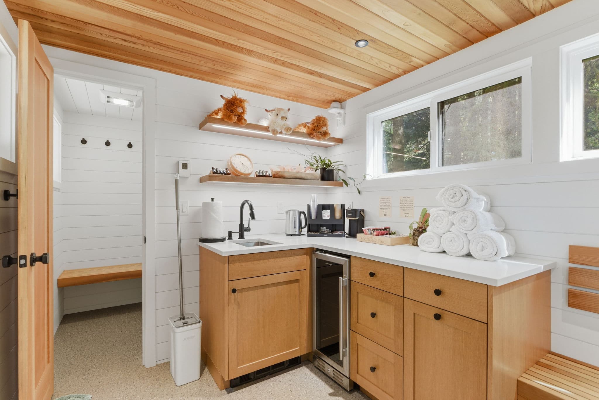 Spa relaxation room with white shiplap, cedar ceiling, and rolled towels